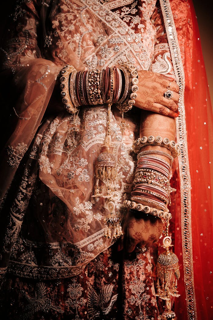 Close up of Bride in Traditional Clothing , bridal wear Isha designer , weeding dress , Dulhan dress , wedding lehenga, red lehenga for wedding , royal red lehenga, designer red lehenga, dark red lehenga red lehenga with golden sequence work , red lehenga with golden embroidrary